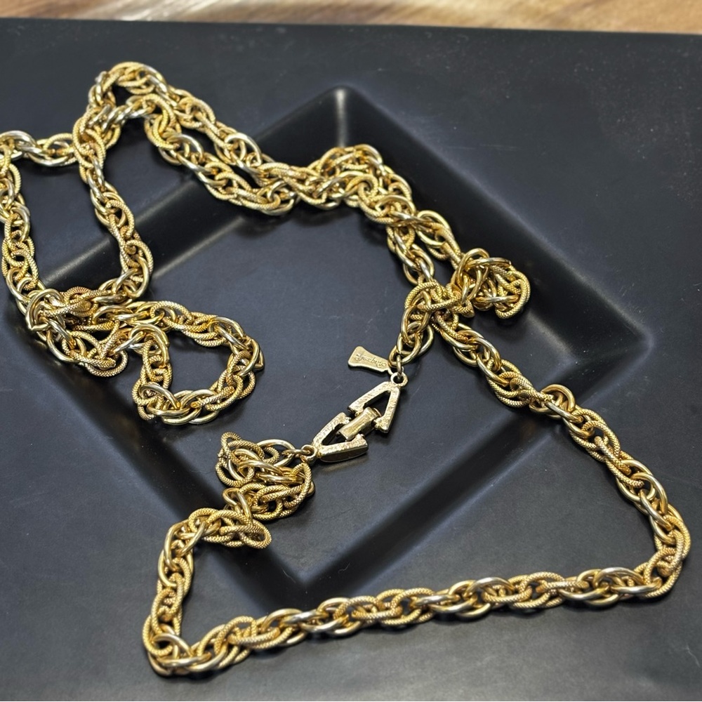 Vintage gold tone textured rope chain necklace signed Raquel, 35 inches.